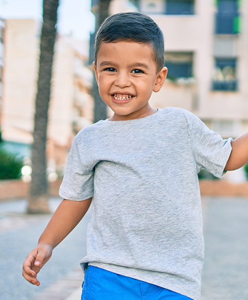 Smiling young boy wearing a gray T-shirt