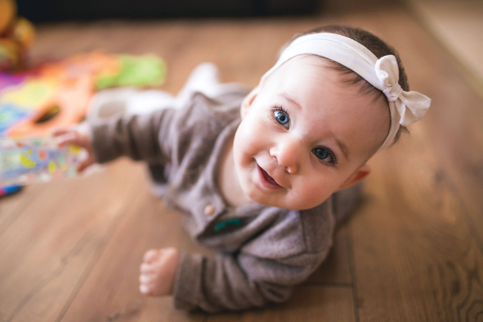 Infant happily playing with toys