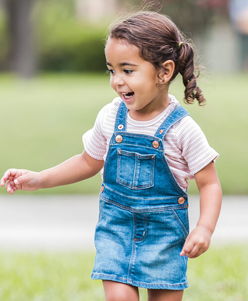 Happy young girl playing outdoors